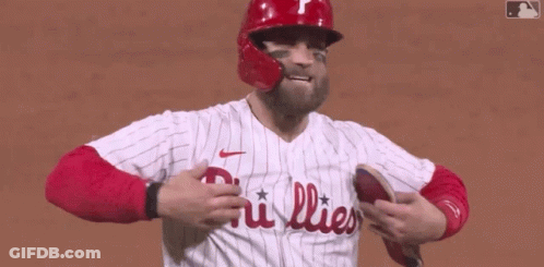 A Phillies Baseball Player Wearing A Red Helmet And A White Jersey GIF