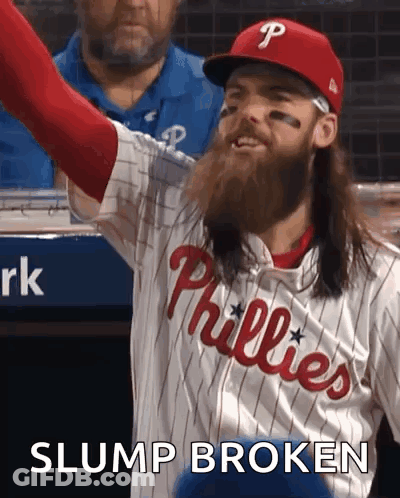 A Phillies Baseball Player With Long Hair And A Beard Is Celebrating GIF