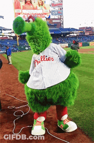 A Phillies Mascot Is Standing On The Field GIF