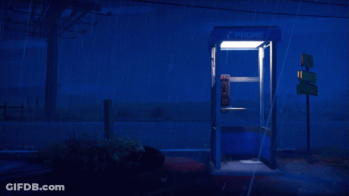A Phone Booth Is Lit Up In The Dark GIF