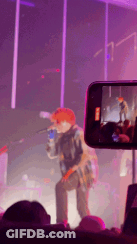 A Phone Is Taking A Picture Of A Man On Stage GIF