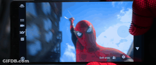 A Phone Screen Shows A Picture Of A Spiderman Holding A Sword And Says Soft Snap GIF
