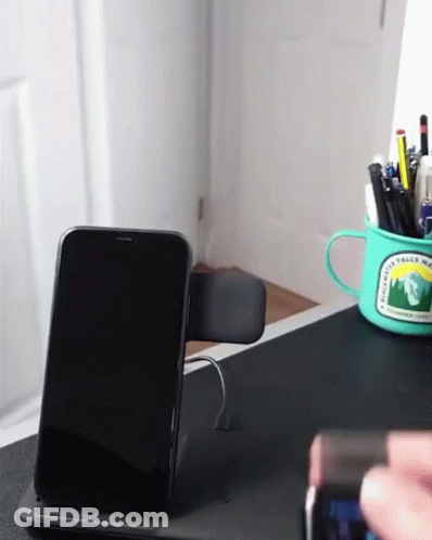 A Phone Sitting On A Desk Next To A Mug That Says Rainwater Valley National Park GIF