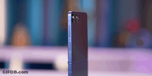A Phone With A Camera On The Back Is Sitting On A Table GIF
