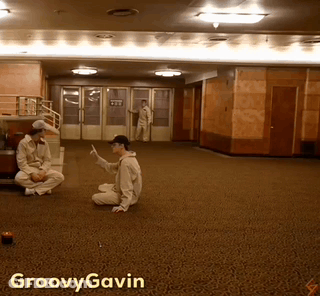 A Photo Of A Man Sitting On The Floor With Groovy Gavin Written On The Bottom GIF