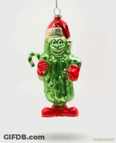 A Pickle Ornament With A Santa Hat And Candy Cane GIF