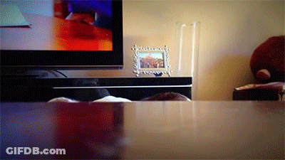 A Picture Frame On A Table Next To A Television GIF