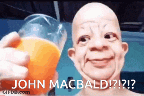 A Picture Of A Bald Man Holding A Glass Of Orange Juice With The Caption " John Macbald " GIF