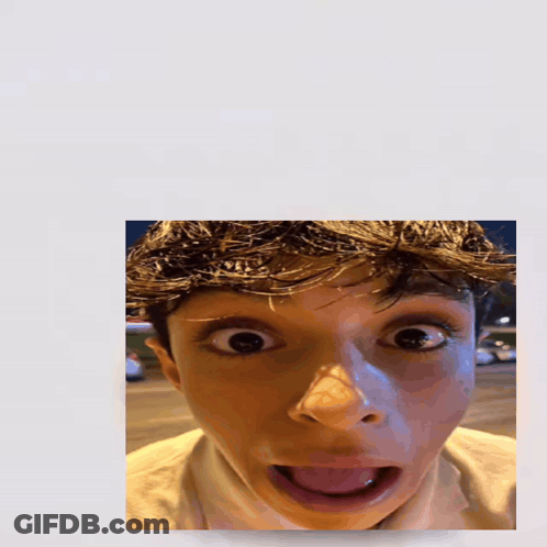 A Picture Of A Boy With His Tongue Out And The Word Holy Above Him GIF