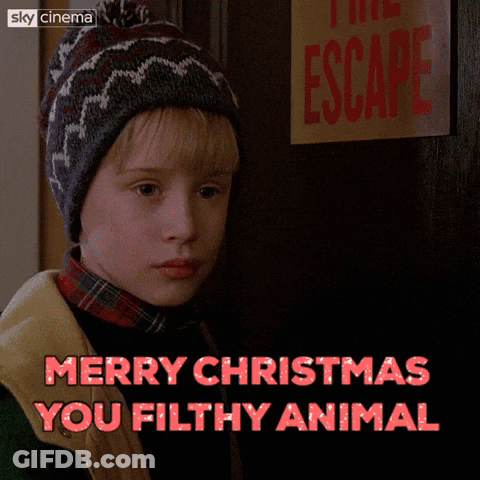 A Picture Of A Boy With The Words Merry Christmas You Filthy Animal Above Him GIF