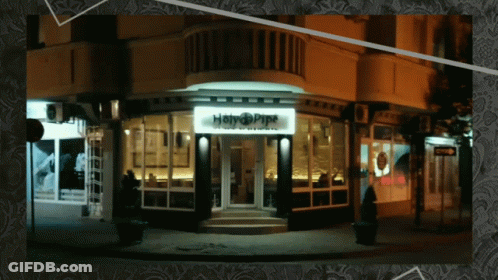 A Picture Of A Building With A Sign That Says Happy Pipe GIF