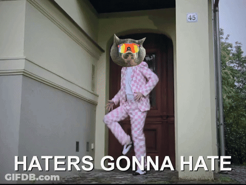 A Picture Of A Cat In A Pink Suit With Haters Gonna Hate Written On It GIF