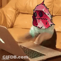 A Picture Of A Cat Using A Laptop With A Drawing Of A Monster On It GIF