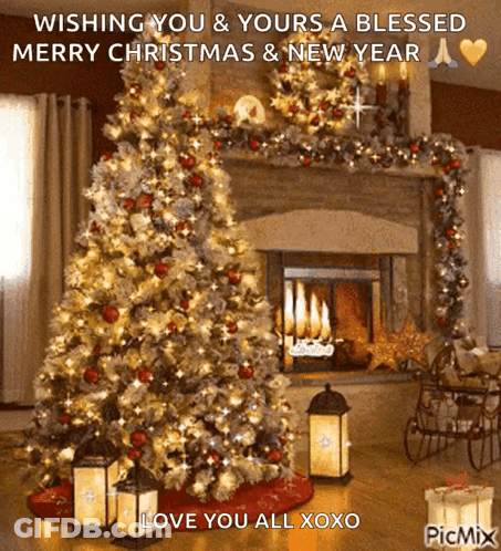 A Picture Of A Christmas Tree In Front Of A Fireplace Wishing You And Yours A Blessed Merry Christmas GIF