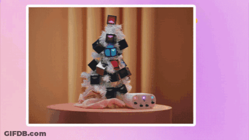 A Picture Of A Christmas Tree With Gifts On It GIF
