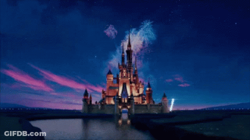 A Picture Of A Disney Castle With A Mickey Mouse Head In The Background GIF