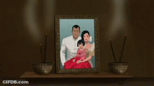 A Picture Of A Family Is Framed On A Table With Two Bowls Of Incense In Front Of It GIF