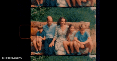 A Picture Of A Family Sitting On A Rock With A Black Background GIF