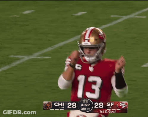 A Picture Of A Football Player With The Words Tough Down Behind Him GIF