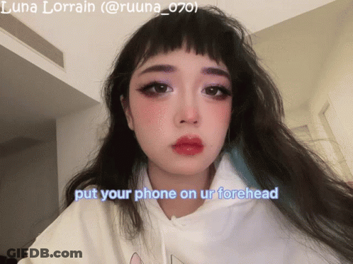 A Picture Of A Girl With The Words Put Your Phone On Ur Forehead GIF
