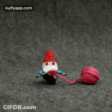 A Picture Of A Gnome Knitting With The Website Kulfyapp.com In The Upper Right Corner GIF