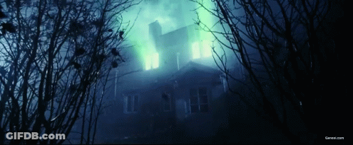 A Picture Of A Haunted House With A Green Light Coming From The Windows GIF