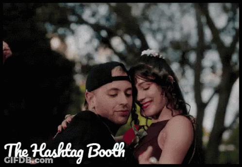 A Picture Of A Man And Woman With The Words " The Hashtag Booth " Below Them GIF