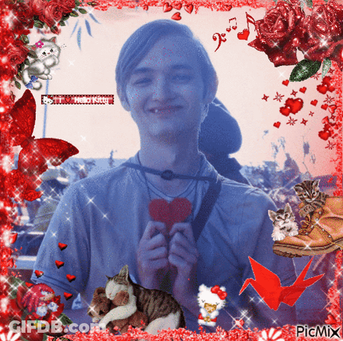 A Picture Of A Man Holding A Heart Is Surrounded By Red Flowers GIF