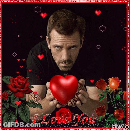 A Picture Of A Man Holding A Red Heart With The Words I Love You Written On The Bottom GIF