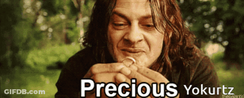 A Picture Of A Man Holding A Ring With The Words Precious Yokurtz Above Him GIF