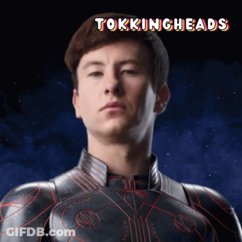 A Picture Of A Man In A Superhero Suit With The Words Tokingheads Above Him GIF
