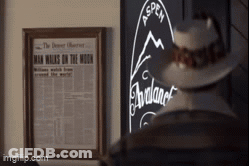 A Picture Of A Man Walking On The Moon Is Hanging On A Wall GIF