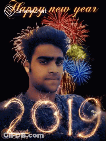 A Picture Of A Man With Fireworks In The Background And The Year 2019 GIF