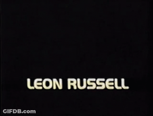 A Picture Of A Man With The Name Leon Russell On The Bottom GIF