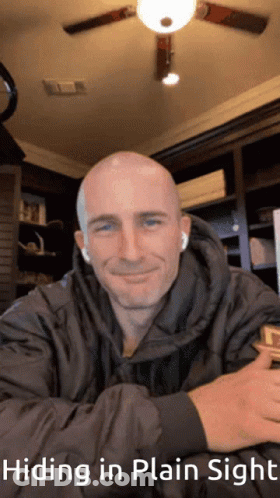 A Picture Of A Man With The Words Hiding In Plain Sight Below It GIF