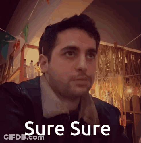 A Picture Of A Man With The Words Sure Sure Written Below Him GIF
