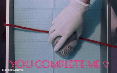 A Picture Of A Person Holding A Heart And The Words You Complete Me GIF