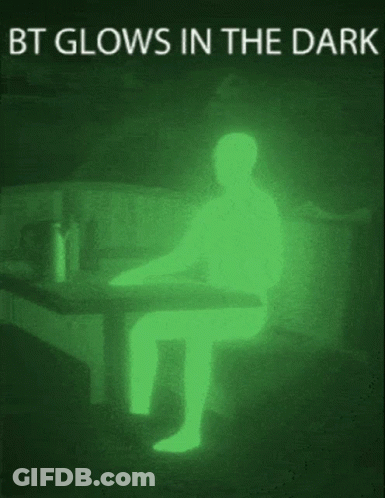 A Picture Of A Person Sitting At A Table That Is Glowing In The Dark GIF