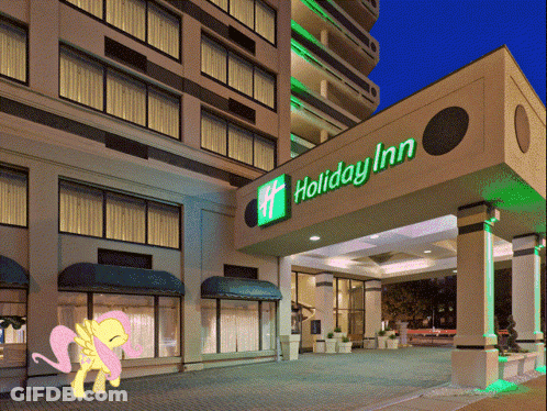 A Picture Of A Pony In Front Of A Holiday Inn Hotel GIF