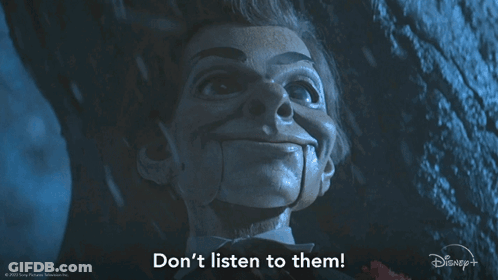 A Picture Of A Puppet With The Words " Do N't Listen To Them " Below It GIF