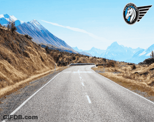 A Picture Of A Road With Mountains In The Background And A Logo That Says Big Horse Tires GIF
