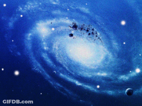 A Picture Of A Spiral Galaxy With A Planet In The Foreground GIF