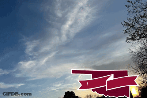 A Picture Of A Sunset With A Red And White Arrow Pointing To The Right GIF