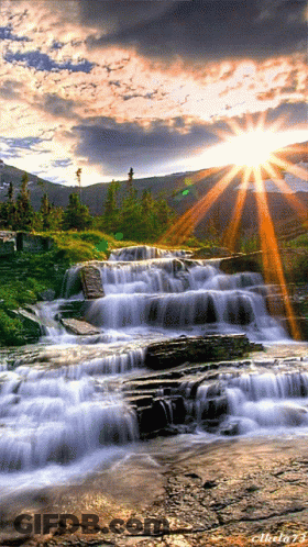 A Picture Of A Waterfall With The Sun Shining Through The Clouds And The Number 73 On The Bottom GIF