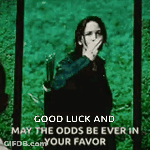A Picture Of A Woman Covering Her Mouth With Her Hand With The Words Good Luck And May The Odds Be Ever In Your Favor . GIF