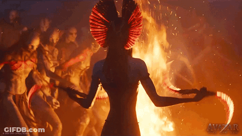 A Picture Of A Woman Dancing In Front Of A Fire With Avizar Written On The Bottom Right GIF