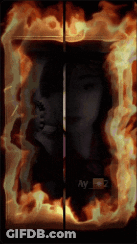 A Picture Of A Woman Is Surrounded By Flames And The Name Ay Is On The Bottom GIF