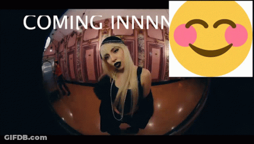A Picture Of A Woman Next To A Smiley Face That Says Coming Innnnn GIF