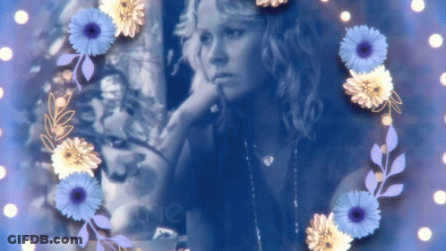 A Picture Of A Woman Surrounded By Blue And Yellow Flowers With The Word Mer On The Bottom GIF
