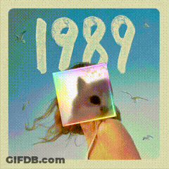 A Picture Of A Woman With A Cat In Front Of Her Face And The Year 1989 GIF